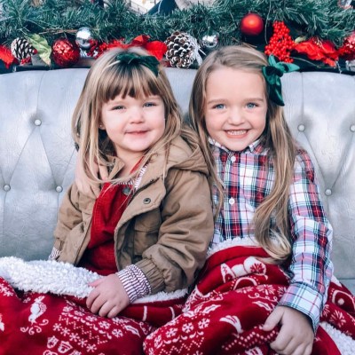 a group of young children sitting next to a little girl