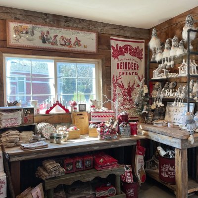 a room filled with furniture and vase on display in a store