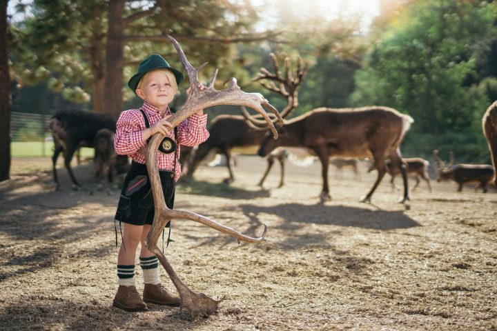 a little girl walking down a dirt road