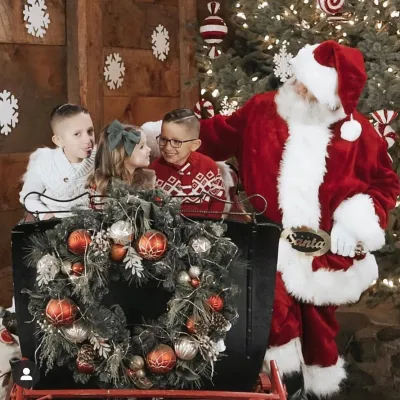 a group of teddy bears sitting next to a christmas tree