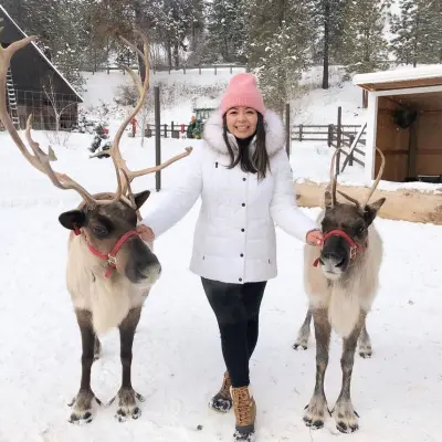 a person and a dog on a leash in snow