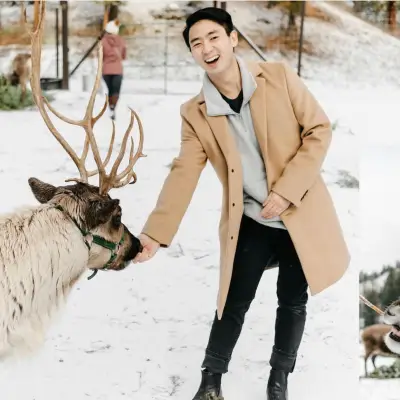 a person and a dog are walking in the snow